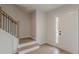 Inviting foyer with wood-look floors, staircase with black iron spindles, and natural light at 2724 Kristen Ct, Conyers, GA 30012