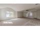 Expansive carpeted main bedroom with tray ceiling, ceiling fan, and natural light at 2724 Kristen Ct, Conyers, GA 30012