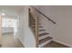 Elegant staircase featuring wood treads, white risers, and a modern black iron railing at 2724 Kristen Ct, Conyers, GA 30012