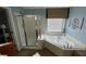 Bathroom with a shower and a tub at 4107 Suwanee Trail Way, Buford, GA 30518