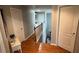 Hallway with hardwood floors and a view of the staircase at 4107 Suwanee Trail Way, Buford, GA 30518