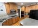 Modern kitchen featuring stainless steel appliances, granite countertops, and wooden cabinets at 4107 Suwanee Trail Way, Buford, GA 30518