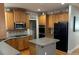 Well-lit kitchen with wooden cabinets, stainless steel appliances, and center island at 4107 Suwanee Trail Way, Buford, GA 30518