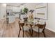 Stylish dining area with a glass table, modern chairs, and a view into the bright, white kitchen at 9458 Cedar Grove Ct # 330, Jonesboro, GA 30238