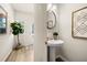 Hallway powder room with decorative mirror and pedestal sink at 9458 Cedar Grove Ct # 330, Jonesboro, GA 30238