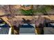 Aerial view of a property showcasing a well-maintained backyard, mature trees, and neighborhood surroundings at 203 Roseman Way, Woodstock, GA 30188