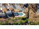 Aerial view of community pool and recreation area nestled among mature trees and lush landscaping at 203 Roseman Way, Woodstock, GA 30188