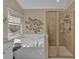 Bright bathroom featuring a large soaking tub, decorative wall art, and a tiled glass shower enclosure at 203 Roseman Way, Woodstock, GA 30188