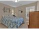 Cozy bedroom with a comfortable bed, neutral walls, and a window with plantation shutters at 203 Roseman Way, Woodstock, GA 30188