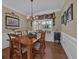 An elegant dining room features a wooden table, ornate chandelier, and decorative accents at 203 Roseman Way, Woodstock, GA 30188