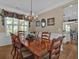 A formal dining room features an ornate chandelier and a view into the kitchen at 203 Roseman Way, Woodstock, GA 30188