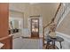 Welcoming foyer with a grand staircase, hardwood floors, and an open view of the home office at 203 Roseman Way, Woodstock, GA 30188