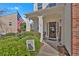 Inviting front entrance with a covered porch, decorative columns, and manicured landscaping at 203 Roseman Way, Woodstock, GA 30188