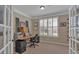Functional home office with natural light, neutral decor, and built-in shelving at 203 Roseman Way, Woodstock, GA 30188