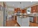 A well-appointed kitchen features stainless steel appliances, granite countertops, and wooden cabinets at 203 Roseman Way, Woodstock, GA 30188