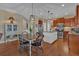 Open kitchen with a center island and stainless steel appliances flows into the dining area at 203 Roseman Way, Woodstock, GA 30188