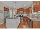 This kitchen features granite countertops, a center island, and stainless steel appliances at 203 Roseman Way, Woodstock, GA 30188