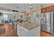 Open kitchen with a center island and stainless steel appliances flows into the living room at 203 Roseman Way, Woodstock, GA 30188