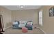 Relaxing living room with a comfortable couch, and a window with plantation shutters at 203 Roseman Way, Woodstock, GA 30188
