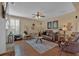 Inviting living room featuring hardwood floors, ceiling fan, and comfortable leather seating at 203 Roseman Way, Woodstock, GA 30188