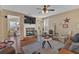 Cozy living room showcases stone fireplace, plush seating, and abundant natural light from the windows at 203 Roseman Way, Woodstock, GA 30188