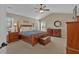 Spacious main bedroom with a king-size bed, ceiling fan, and ample natural light at 203 Roseman Way, Woodstock, GA 30188