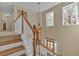 Elegant staircase with wooden railings and a stylish chandelier, creating a grand entrance at 203 Roseman Way, Woodstock, GA 30188