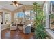 Bright sun room filled with natural light, featuring hardwood floors and inviting seating at 203 Roseman Way, Woodstock, GA 30188