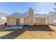 Backyard with a concrete patio, beige siding, a chimney, and a large grassy area at 5193 Seaside Ct, Atlanta, GA 30349