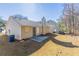 Backyard with a concrete patio, beige siding, a chimney, and a large grassy area at 5193 Seaside Ct, Atlanta, GA 30349