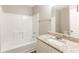 Bathroom with a single sink vanity with a granite countertop, a white shower and tub, and neutral paint at 5193 Seaside Ct, Atlanta, GA 30349