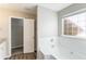 Bathroom featuring a tub, tiled wall, granite countertop and wood-look flooring at 5193 Seaside Ct, Atlanta, GA 30349