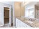 Bathroom featuring granite countertops, a sink, large mirror, and tub shower at 5193 Seaside Ct, Atlanta, GA 30349