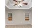 Spacious bedroom featuring a tray ceiling with a ceiling fan and two windows at 5193 Seaside Ct, Atlanta, GA 30349