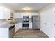 Bright kitchen with stainless steel appliances, granite countertops, and white cabinetry at 5193 Seaside Ct, Atlanta, GA 30349