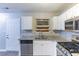 Spacious kitchen featuring a stainless steel dishwasher, range and a granite countertop at 5193 Seaside Ct, Atlanta, GA 30349