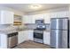 Bright kitchen with stainless steel appliances, granite countertops, and white cabinetry at 5193 Seaside Ct, Atlanta, GA 30349
