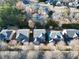 Aerial view of homes in the community with manicured lawns and mature trees at 120 Daniel Creek Ln, Sugar Hill, GA 30518