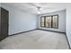 Spacious bedroom with a ceiling fan and natural light from large windows at 120 Daniel Creek Ln, Sugar Hill, GA 30518