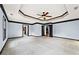 Large bedroom featuring a tray ceiling, carpeting, and entryways to other rooms at 120 Daniel Creek Ln, Sugar Hill, GA 30518