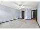 Large carpeted bedroom with ceiling fan, and a doorway leading to an adjacent room at 120 Daniel Creek Ln, Sugar Hill, GA 30518