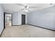 Spacious bedroom featuring plush carpeting, a ceiling fan, and plenty of natural light at 120 Daniel Creek Ln, Sugar Hill, GA 30518