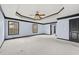 Large primary bedroom featuring a tray ceiling, carpeting, and two windows for natural light at 120 Daniel Creek Ln, Sugar Hill, GA 30518