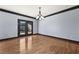 Bright dining room with hardwood floors and double doors at 120 Daniel Creek Ln, Sugar Hill, GA 30518