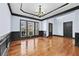 Elegant dining room featuring hardwood floors, wainscoting and a modern chandelier at 120 Daniel Creek Ln, Sugar Hill, GA 30518