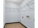 Functional laundry room with tile flooring, wire shelving, and utility connections at 120 Daniel Creek Ln, Sugar Hill, GA 30518