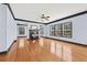 Expansive living room boasting hardwood floors, a fireplace, and large windows at 120 Daniel Creek Ln, Sugar Hill, GA 30518