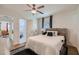 Neutral bedroom with a ceiling fan, light wood floors, and a view into the ensuite bathroom at 1801 Beecher Sw St, Atlanta, GA 30310