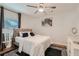 Bright bedroom featuring a ceiling fan, neutral decor, and a plush bed with decorative pillows at 1801 Beecher Sw St, Atlanta, GA 30310