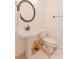 Cozy powder room with pedestal sink, toilet, decorative mirror and earth-toned accents at 2474 Starfire Ln, Loganville, GA 30052